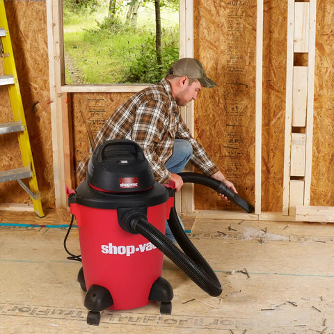 Person using Heavy Duty 6 Gallon Wet Dry Vacuum With 3.0 Peak HP, 3 In 1 Function, in a workshop setting.
