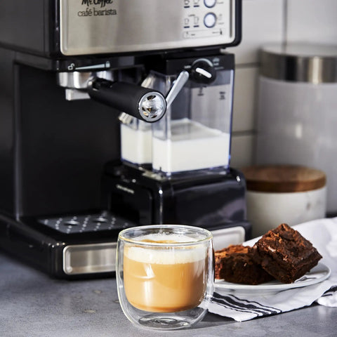 Three In One Espresso And Cappuccino Machine With Stainless Steel Body Programmable Coffee Maker Automatic Milk Frother 15 Bar Pump Brews Lattes Cappuccinos And Espressos At Home Like A Pro next to latte and brownies.