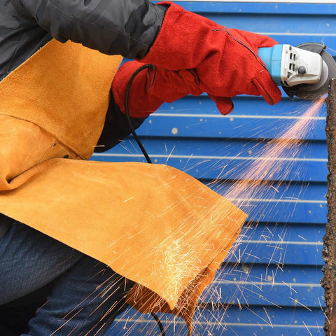 Person using angle grinder wearing Heavy Duty Leather Welding Apron, Flame and Spark Resistant Bib, 23x35 Inches, Safety Smock.