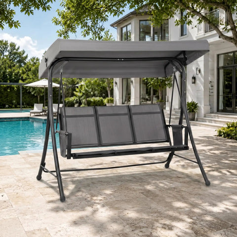 Gray three seat patio swing with adjustable tilt canopy, easy setup metal frame on stand by a poolside terrace