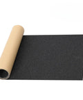 Grippy Grip Tape For Skateboards And Scooters 33 Inch By 9 Inch Black No Air Bubbles Durable Sandpaper Unrolled on White Background