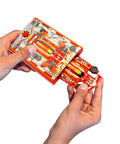 Hands holding Pocket Size Racecar Launcher With Real Rubber Tires For High Speed Racing Transforms Card Racer Into Ultra Fast Car.