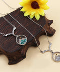 Faith Boost Mustard Seed Pendant Necklace for Women with V Shaped Stainless Steel Design and Cubic Zirconia Accents on display.