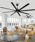 Beefy 96 Inch Industrial DC Motor Ceiling Fan With 8 Reversible Blades installed in a modern commercial dining area with wooden chairs