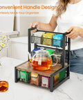 Industrial Rustic Tea Bag Organizer, 3 Tier Wood Storage Box With Drawer on countertop with glass teapot, woman holding handle