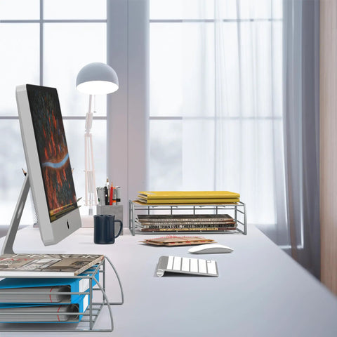 Modern office desk with computer monitor, desk lamp, and stackable metal file organizers holding paper and files.