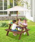 Outdoor Wooden Kids Picnic Table With Removable Umbrella Foldable Bench Set For Backyards And Patios Toddler Friendly Outdoor Furniture In Walnut Durable Safe Shade For Boys And Girls Great Gift with children playing in a backyard.