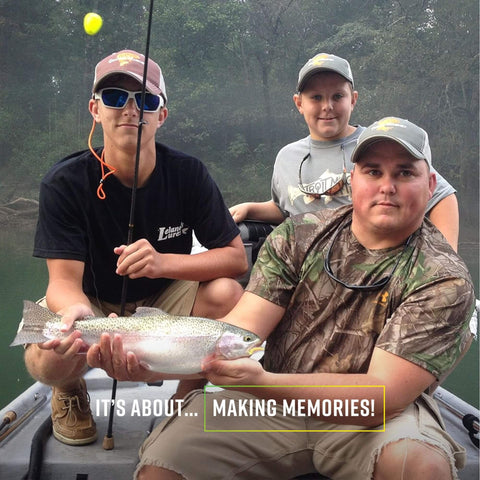 Three people fishing on a boat, holding a caught trout, with Original Slotted Trout Floats in use for depth adjustment.