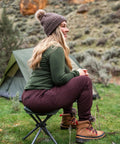 Person sitting on Apex Fold-Up Stool G-140 Black Grey Ultra Portable Camp Seat in outdoor campsite setting