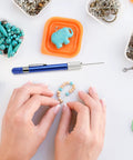 Hands crafting with 21-Piece Drill Bit Set With Pin Vise For Jewelry Bead Making And Tiny Wood Carving on a table with beads and tools
