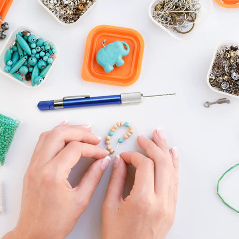 Hands crafting with 21-Piece Drill Bit Set With Pin Vise For Jewelry Bead Making And Tiny Wood Carving on a table with beads and tools