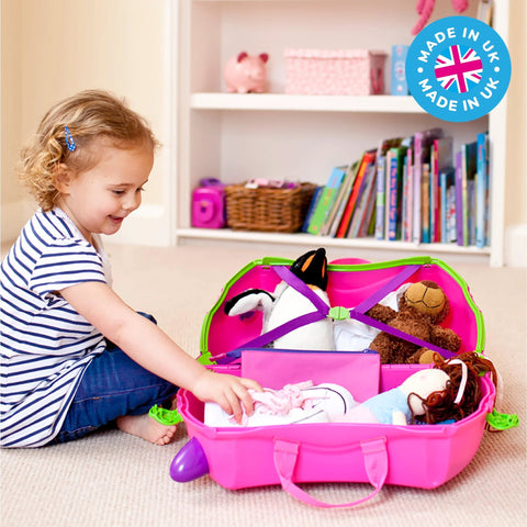 Child packing pink kids ride-on luggage with toys