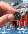 Holding a black rubber pegboard clip next to hooks, used for inventory control on slatwall and pegboard hooks.