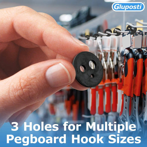 Holding a black rubber pegboard clip next to hooks, used for inventory control on slatwall and pegboard hooks.