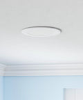 Ceiling with a Sixteen Pack 6 Inch LED Recessed Downlights Dimmable Easy Install 5 CCT 2700K to 5000K 1050 Lumens 12W fixture installed.