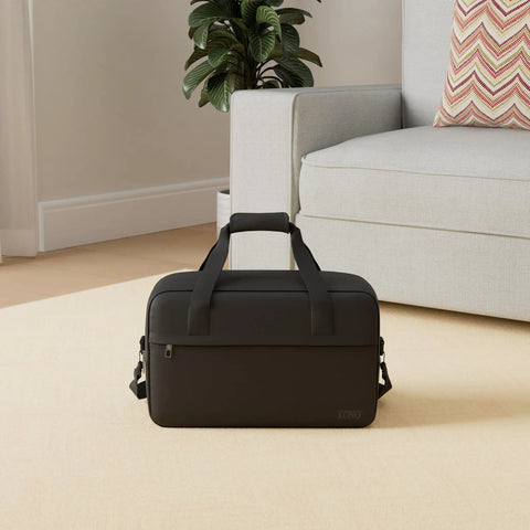 Underseat Carry On Duffle Bag 20L For Plane Travel, Gym, And Weekend Getaway, Compact 15.75 By 9.84 By 7.87 Inches in black on floor.