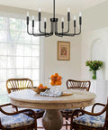 Killer 8 Light Black Chandelier With Dang Sharp Matte Finish For Farmhouse Dining Room And Kitchen Island above a wooden dining table.