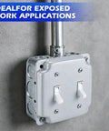 Two Gang Double Switch Box Kit With 4x4 Inch Metal Electrical Box And Two 15 Amp Tamper Resistant Single Pole Toggle Switches on wall