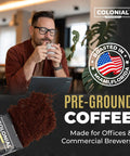 Man enjoying a cup of Colombian Arabica Ground Coffee in an office setting with Pre-Ground Coffee pack visible