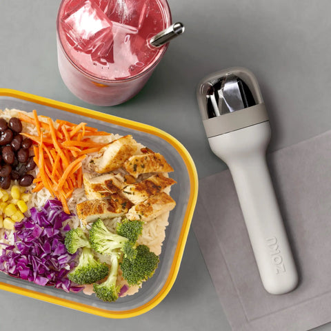 Pocket Utensil Set In Grey With 18/8 Stainless Steel Fork Knife And Spoon Nestled In A Compact Case on table with meal and drink