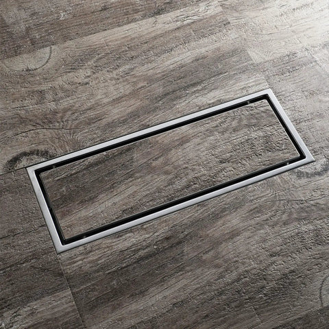 Top Shelf Heavy Duty 304 Stainless Steel Linear Floor Drain With Anti Odor Hair Catcher For Bathroom And Shower Tile Insert Rectangle Black Gold Finish installed in gray textured flooring.