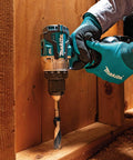 Person using 18V LXT Brushless Compact Hammer Drill Driver One Half Inch Cordless Tool Only, 970 Inch Pounds Max Torque, on wooden surface.