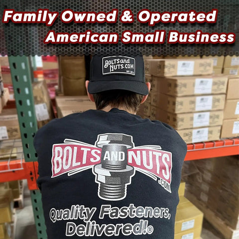 Person wearing 'Bolts and Nuts' shirt and hat in warehouse, showcasing family-owned American small business setting.