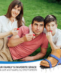Family enjoying lawn with Ready To Use Lawn Aerator Shoes With Adjustable X Straps And Sturdy Spike Platform for soil aeration.