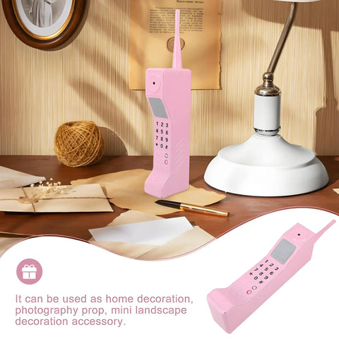 Kickass Vintage Cellphone Prop Cast From Heavy Duty Iron Serving Major Eighties Brick Phone Throwback Aesthetic on wooden desk.