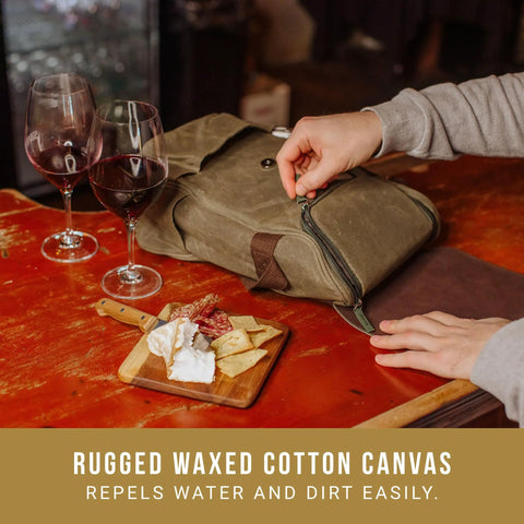Straight Up Insulated Wine Bag With Matching Cheese Board And Sharp Corkscrew Opener Waxed Canvas Cooler Tote For Two Bottles Pocketed Grab And Go Hauler For Weekend Kickbacks In Khaki Green with cheese board and wine glasses.