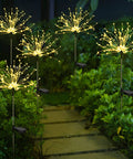 Five Pack Solar Firework String Lights Outdoor Waterproof With 600 LEDs And 40 Flexible Copper Wires illuminating a garden path