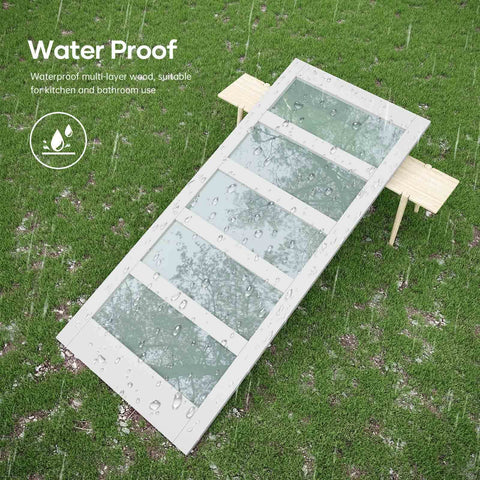 White Frosted Glass Barn Door 48 By 84 Inches With 96 Inch Sliding Hardware Kit Included And Handle PVC Surface Waterproof Simple To Clean Solid Wood Core With Durable MDF Needs Assembly Modern Farmhouse Style shown wet outdoors on grass.