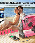 Ultra Portable 30000mAh Solar Fan With LED Lantern And 10W Solar Panel Battery Powered Camping Fan shown on beach with phone charging