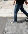 Person walking on a Durable Resin Sewer Manhole Cover And Frame With Easy Lift Handle For Garden Yard And Lawn Weather Resistant Plastic Access Hatch 40 By 40 Cm Easy Drainage Solution For Inspection And Maintenance