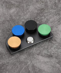 Stainless Steel Watch Oil Dip Tool With Lid Four Eye Oil Dish on gray surface, multicolored lids