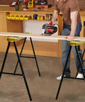Rock Solid Portable Folding Sawhorse Heavy Duty Steel Work Stand Twin Pack With Anti Slip Eva Work Surface And Built In Carry Handle For Tradesmen And Diy Crafters Quick Fold Design being used for cutting wood.