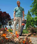 Man using 12 Amp Electric Leaf Blower With Turbine Tech For Lightning Fast Yard Cleanups 600 CFM 2 Speed Control Corded Power WG520