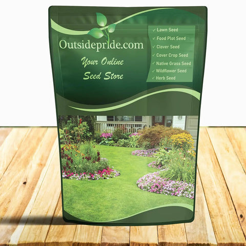 Green bag labeled 'Outsidepride.com Your Online Seed Store' on wooden surface, featuring a garden image with lawn and flowers.