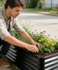 Man planting flowers in Raised Garden Bed Kit 6x3x1 Ft Metal Planter Boxes Outdoor With No Fuss Easy Assembly For Vegetables Fruits Flowers And Herbs Large Rectangle Garden Bed In Dark Gray Durable Galvanized Steel Construction.