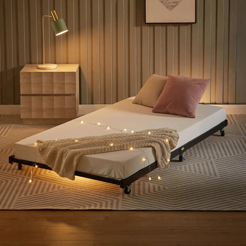Heavy Duty Twin Trundle Bed Frame Built Tough For Casual Hangouts And Epic Sleepovers Featuring Roll Out Guest Sleeping Platform Base Zero Sag Steel Slats And Easy Glide Lockable Casters Black with decorative lights and pillows.