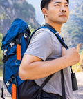 Hiker with backpack featuring Two Pack Paracord Keychain Hook With Carabiner Clip And Orange Braided Strap Locking D Ring Key Ring Holder