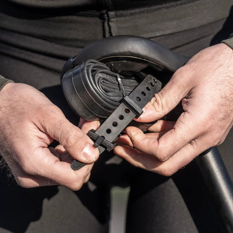 Hands holding Adjustable 360mm Bike Cargo Straps Set For Bikepacking And Carrier Racks Built With TPU For A Strong Grip
