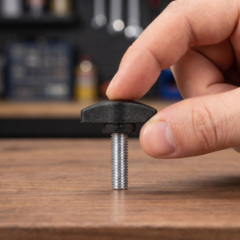 Adjustable Tee Wing Thumb Screws M8x25mm T Shaped Knobs with Black Grip Handle being held over a wooden surface