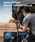 Trail Ready Portable Air Compressor Bad Boy 12 Volt Tire Inflator with digital gauge, user adjusting tire pressure in rugged terrain.