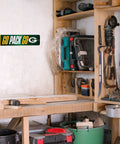 Premium Green Bay Packers Metal Street Sign Wall Art featuring bold team graphics on wall in a workshop setting.