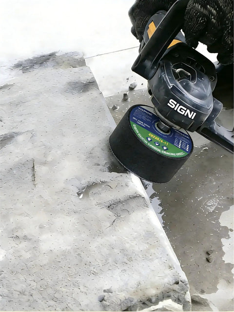 Green 4 Inch Grinding Stone For Angle Grinder, 120 Grit Abrasive Wheel being used on concrete surface by gloved hand