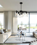 6 Light Modern Farmhouse Black Chandelier For Dining Room installed, showcasing elegant clear glass shades in living room setting