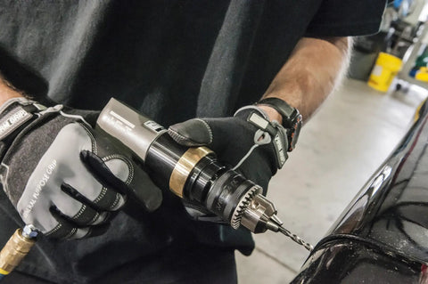 Pro Grade Half Inch Pneumatic Reversible Drill With 800 RPM Lightweight Aluminum Body in use for metalwork