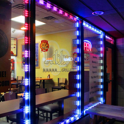 50 Foot LED Light Modules For Storefronts And Signs 100 Pack 0.92W Three LED SMD RGB Waterproof Adhesive Modules For Store Ads And Decor With Seven Color Options illuminating a restaurant window in red, blue, and white colors at night.