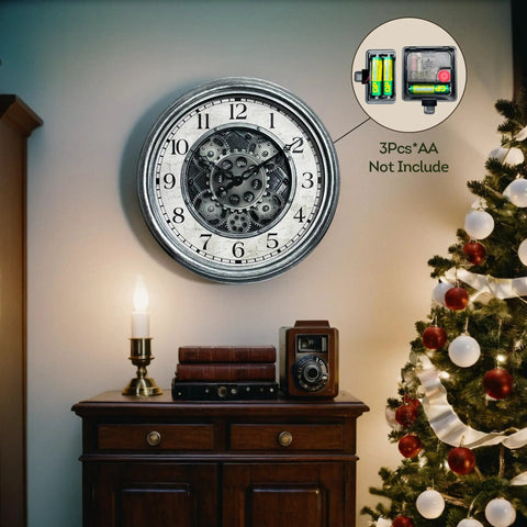 Large 15 Inch Moving Gears Wall Clock In Sleek Silver mounted on wall above a wooden cabinet, features bold numbers, vintage industrial decor.